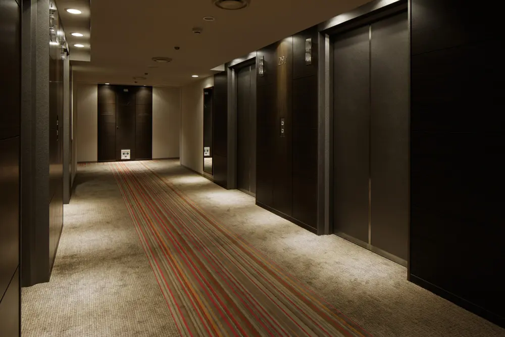 Common area of a guest room floor. Carpet lines represent the illumination of night scenery of "TOKYO".