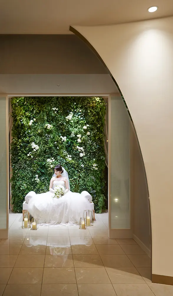 A photo area filled with greenery that illuminates the bride and groom after the wedding ceremony