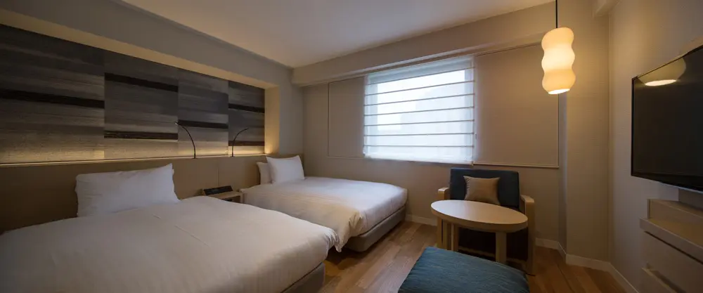 "Premium twin room focused on seniors" with a modern Japanese design and barefoot flooring
