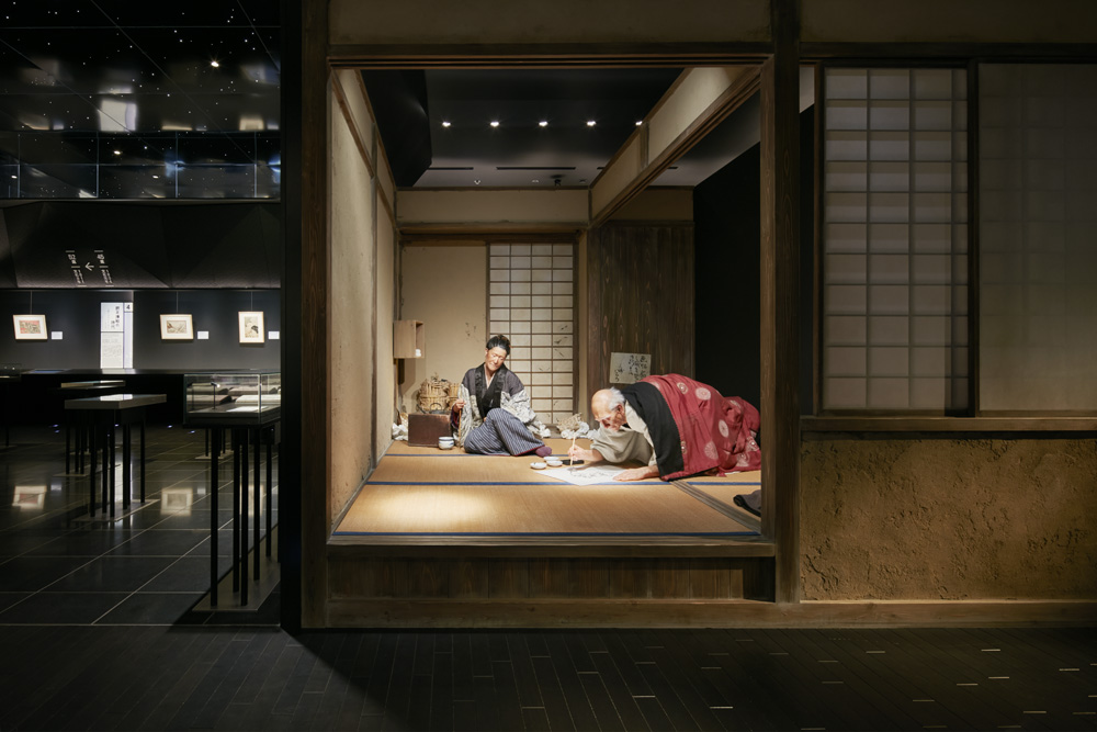A realistic reproduction of Hokusai's studio, featuring life-size models of Hokusai and his daughter Oei