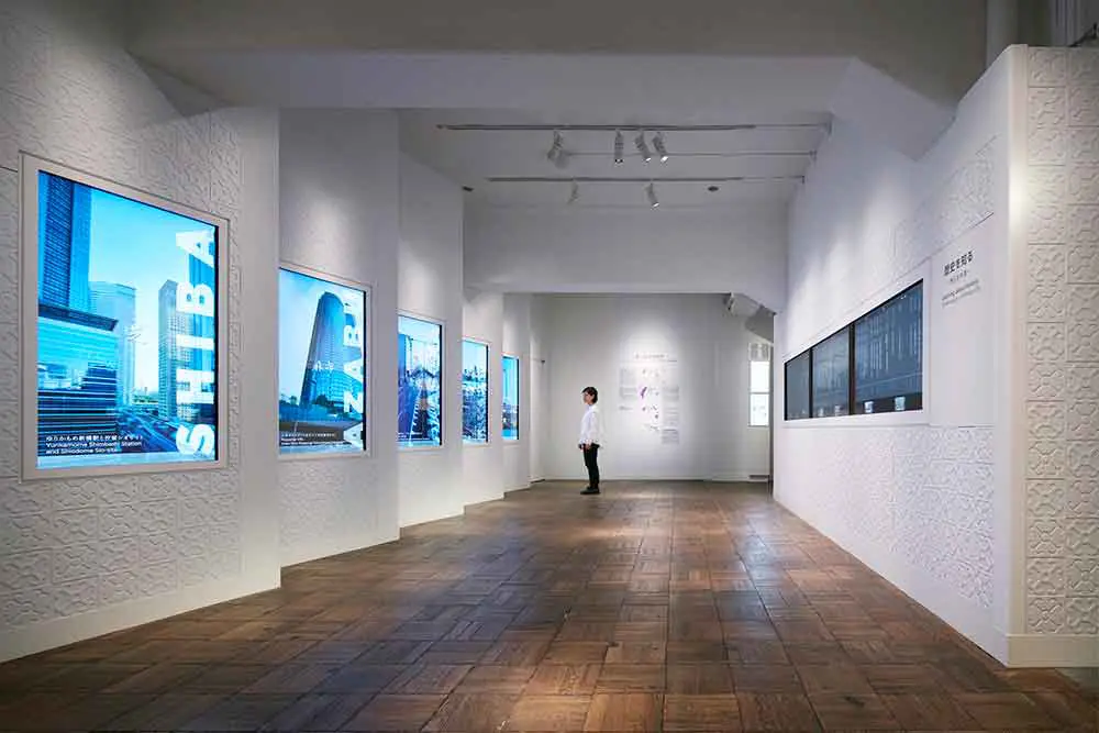 A guidance room introducing the history of MINATO CITY. Patterns extracted from designs found on buildings are expressed in white uneven surfaces on the exhibits.