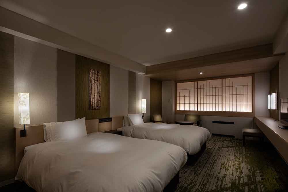 The shoji screen is designed to resemble a mountain range lit up like a paper lantern. Above the headboard is a wooden block of birch artwork and a light with a birch leaf design.