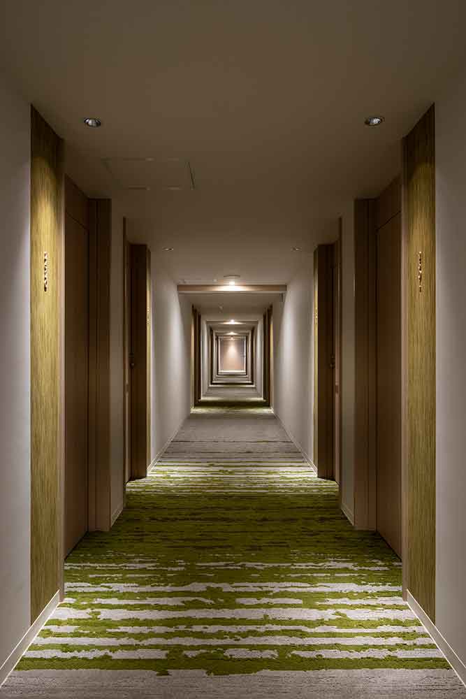The guest room floor corridor is designed to resemble a forest