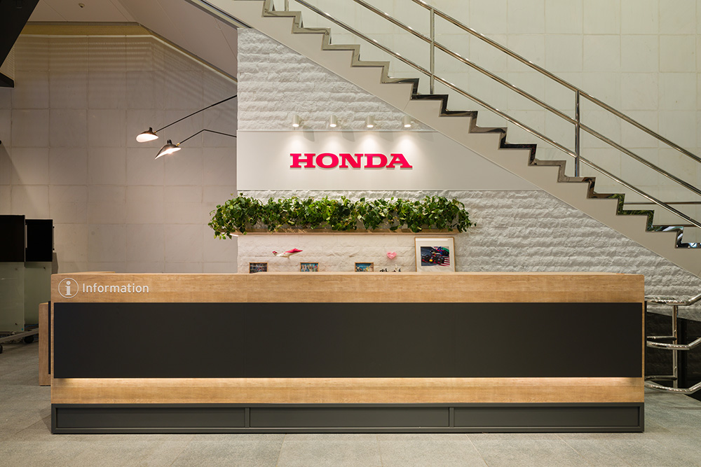 A long, wood-toned counter serves as an information desk to guide customers.