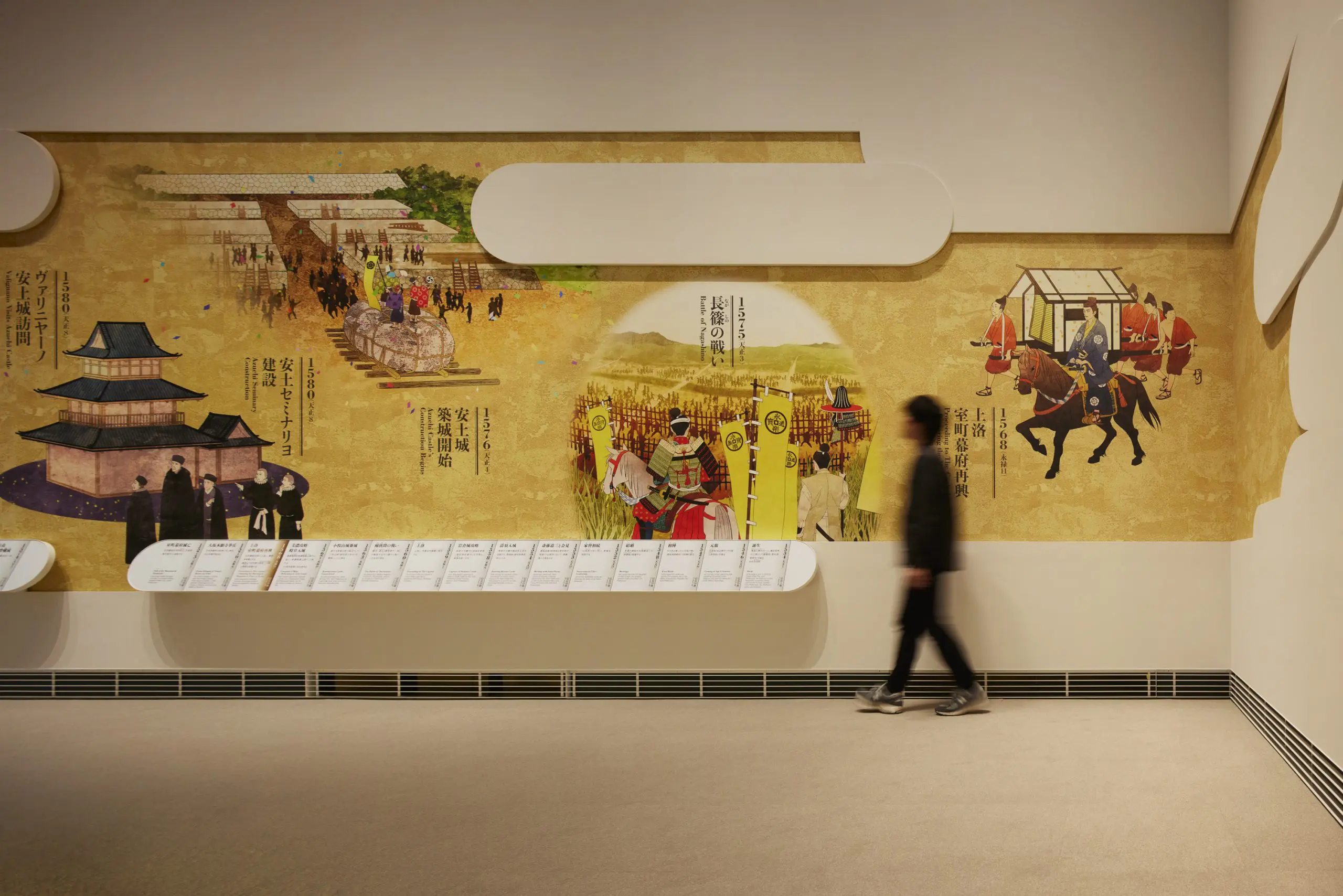 A timeline graphic on the wall, inspired by an illustrated scroll and measuring over 16 meters on each side, adorns the space.
