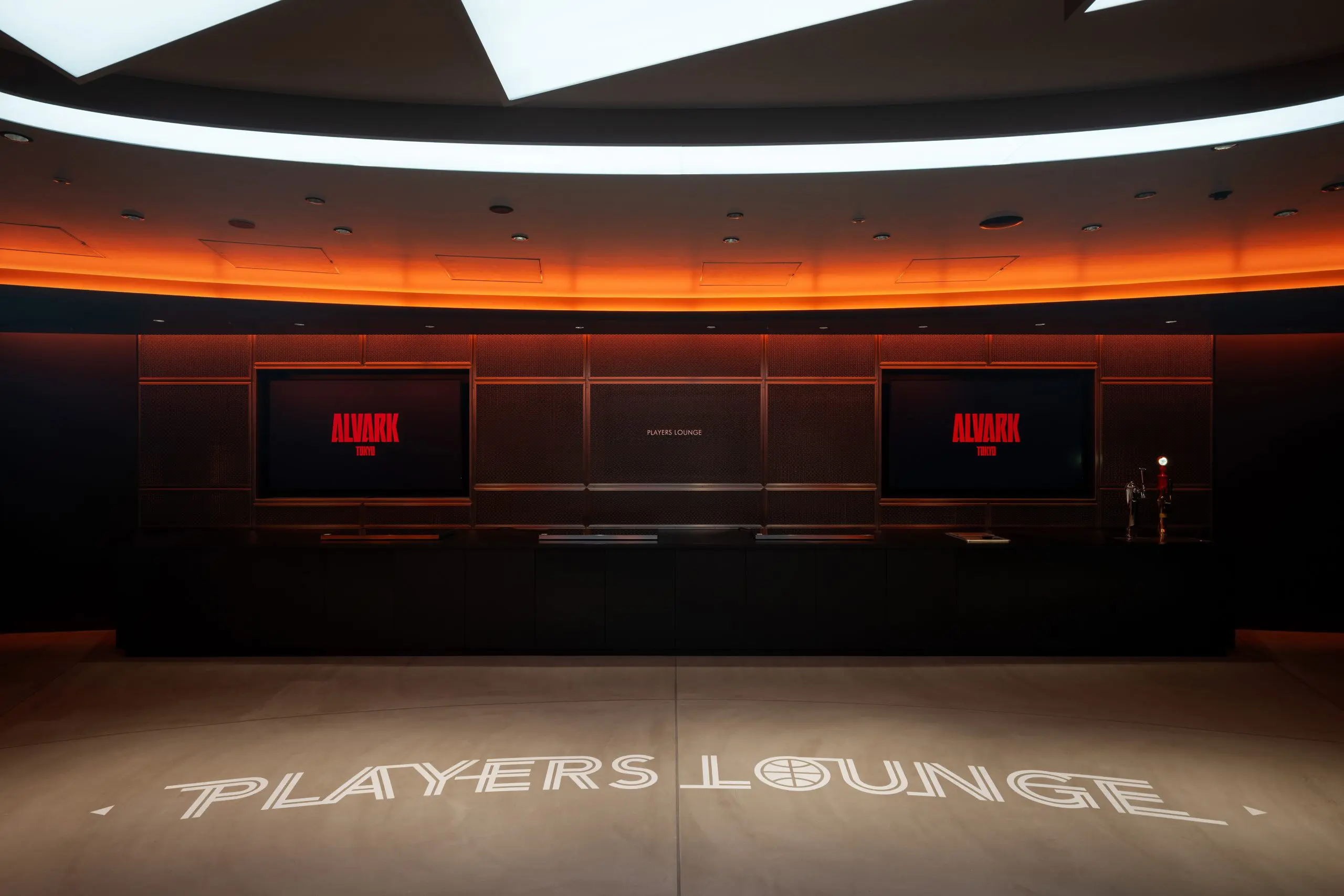 Opposite the players' route are signage and a buffet counter