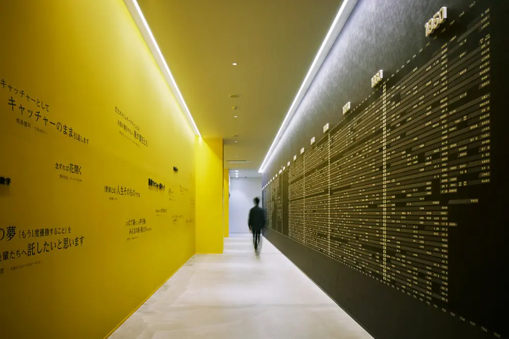 Tigers Road: A long, narrow corridor with a contrasting yellow and black color scheme, the team colors of the Hanshin Tigers. It displays famous quotes from past players and the evolution of uniform numbers from the team's founding to the present.