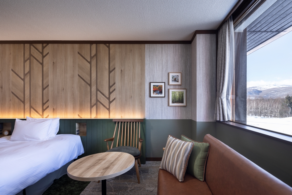 Photographs of the four seasons of Hachimantai are displayed on the walls as artwork. The furniture makes use of the texture of wood Spatial Production a resort feel.