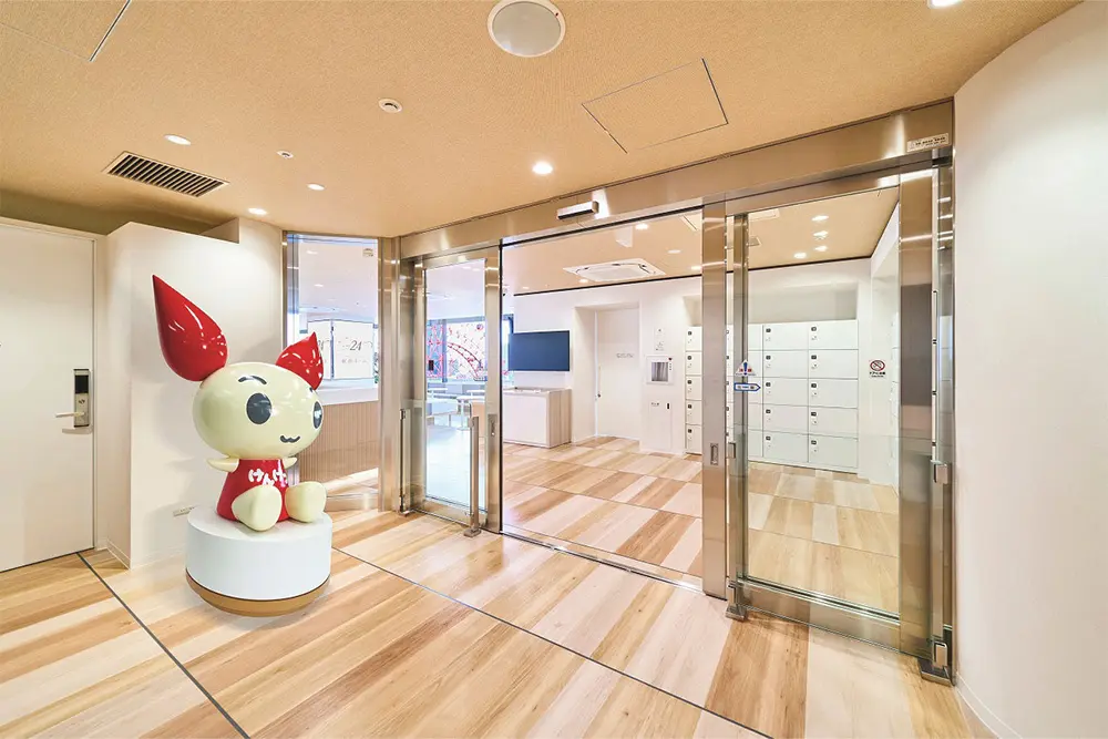 The entrance space is greeted by a large character object.