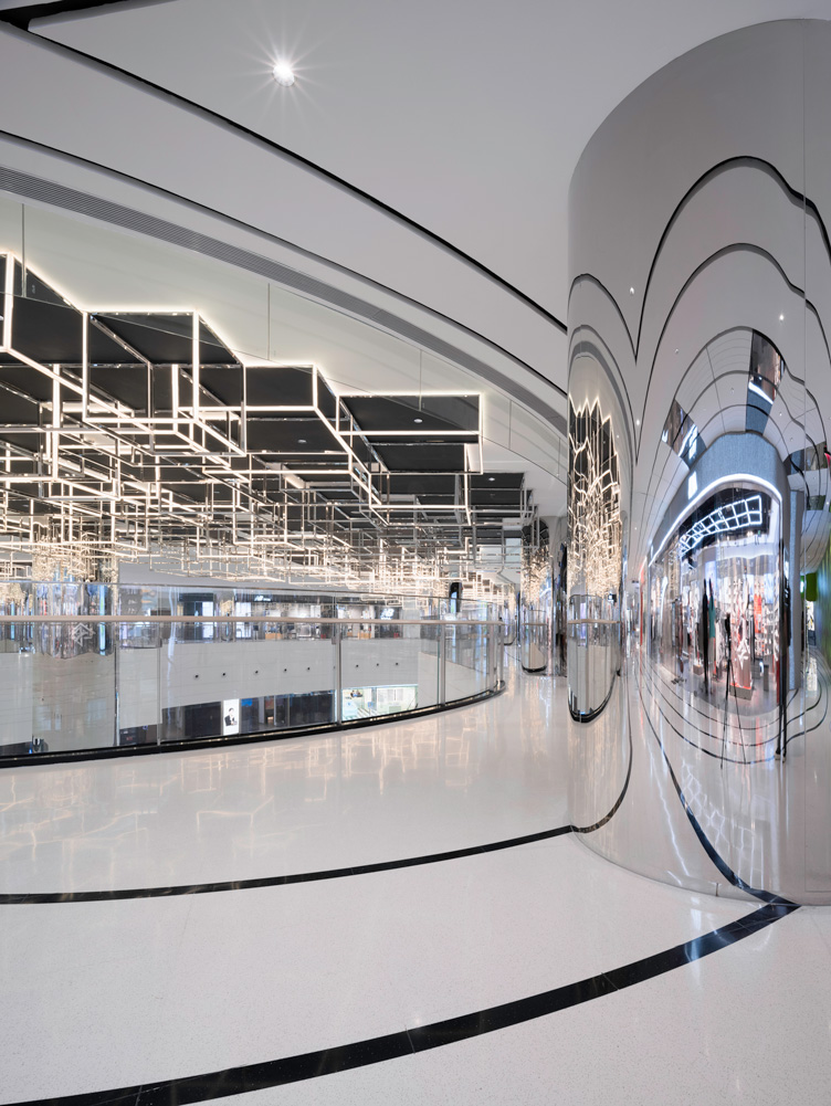 Design elements around the main atrium on the basement levels. The designs of the corridors and atrium are reflected onto the support beams in looped shapes, encouraging horizontal and vertical lines of movement.
