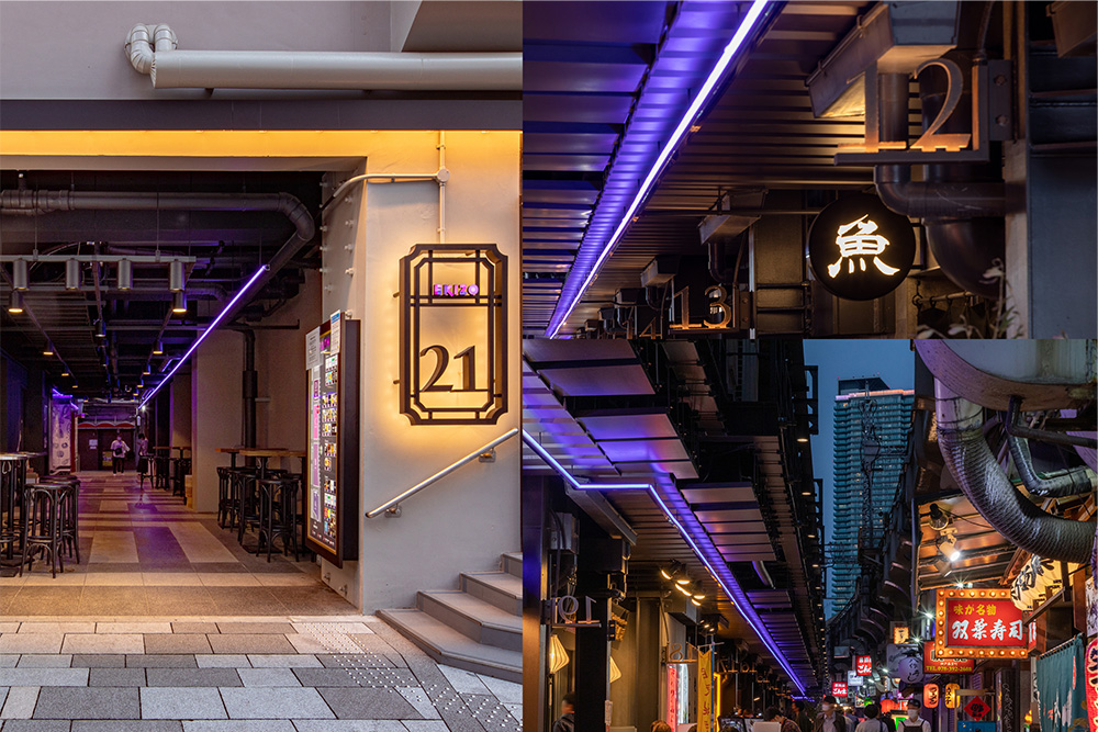 高架下的餐厅区域，仅显示一条蓝色光线的边界。光线增强了回游性，将您带入小巷空间。