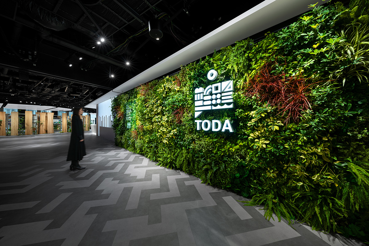 A welcome zone with green walls and Video.